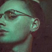 Artist Puma Blue wearing glasses and a silver earring